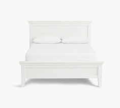 a white bed with two pillows on the headboard and foot board is shown in this image