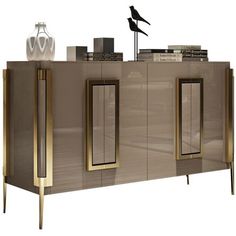 a modern sideboard with three doors and two vases on the top, against a white background