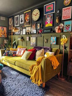 a living room filled with furniture and pictures on the wall