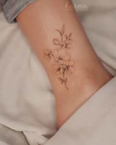 a woman's foot with a flower tattoo on it