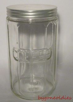 a glass jar with a metal lid on a white surface