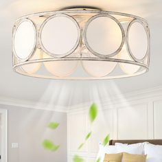 a bed room with a neatly made bed and a round light fixture hanging from the ceiling