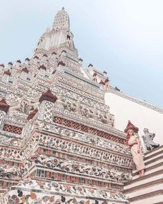 girl walking down steps at wat arun in bangkok, thailand Full Moon Party