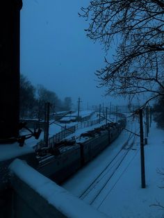 a train traveling down tracks in the snow