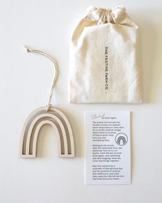 a white bag with a pair of scissors next to it and a wooden brochure