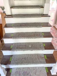 a set of carpeted stairs with writing on them