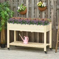 a potted planter sitting on top of a wooden table next to a fence