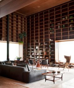 a living room filled with lots of furniture and bookshelves next to each other