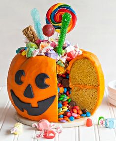 there is a pumpkin shaped cake with candy in it