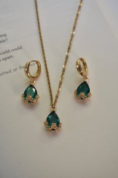 Our Emerald Night Set includes a pair of earrings and a matching necklace. This set can also be sold separately. Color - Green & Gold Material - Stainless Steel & Zinc Alloy measurements - Hoop: 0.5 inches, Earring Drop: 1.20 inches, Necklace Length: 20.5 inches. Green Gifts Aesthetic, Emerald And Gold Jewelry Set, Emerald Jewellery Set, Emerald Sets Jewellery, Deep Winter Jewelry, Gold Emerald Jewelry, Emerald Jewelry Aesthetic, Green And Gold Jewelry, Emerald Jewelry Necklace