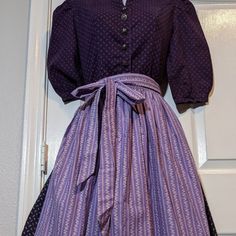 Absolutely Beautiful, Unique, Austrian Dirndl In Two Tone Purple With Split V Neckline, Purple Piping Around The Edges, Six Silver Tirolean Buttons, Puff Sleeves, Smocked Waist And Full Skirt. Comes With Dirndl Apron In Floral Lavender, Smocked Below Waistband. Tags: Oktoberfest, Octoberfest, Casual, Boho, Austria, Germany Brand: Wurzer Dirndl, Austria Size: Extra Small / Small Condition: Good Vintage Condition From A Smoke Free Home - Worn Twice To Two Oktoberfest Festivals! Material: 100% Cotton Measurements, Taken With Garment Laying Flat Dirndl Length: 45 Inches Pit To Pit: 16.5 Inches Waist: 13 Inches Shoulder Width: 13.25 Inches Puff Sleeves: 11 Inches Apron: Length: 27.5 Inches Vintage Austrian Dress, Dirndl Dress Traditional Germany, Dirndl Dress Plus Size, Bavarian Dirndl Traditional Dresses, 1960s Purple Dress, Full Skirt, Dresses Xs, 11 Inches, Puff Sleeves