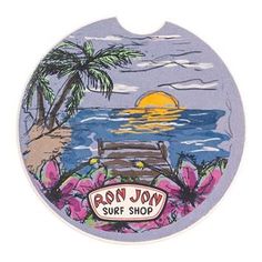 an image of a surf shop sign with flowers and palm trees on the beach at sunset