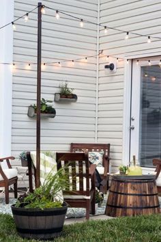 an outdoor patio with potted plants and string lights