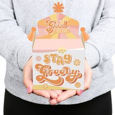 a person holding a box that says stay grooy