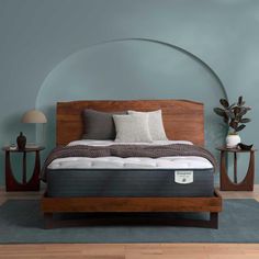 an image of a bed in the middle of a room with blue walls and wood furniture