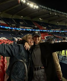 two people taking a selfie at a baseball game