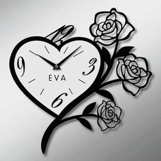 a heart shaped clock with roses on the side and an arrow in the middle that says regal