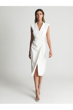 The Cecile in white is a feminine take on the classic tuxedo style. It is a sleeveless, midi-length silhouette that features padded shoulders, peak lapels and a wrap-over fastening to the midriff. This style is a bodycon fit but can also be worn undone over white separates, for a nuanced mood.  Sleeveless Padded shoulders. Peak lapels. Jetted pocket to chest. Wrap-around style. Button close. Bodycon fit. Midi length. Machine washable. 97% Polyester, 3% Elastane. Reiss Women, Classic Tuxedo, Tuxedo Style, White Bodycon Dress, Tuxedo Dress, Bodycon Midi Dress, Dress Shapes, Bodycon Midi