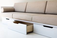 a couch with two drawers underneath it