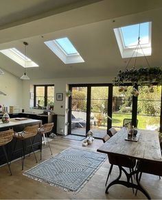 an open kitchen and dining room with skylights