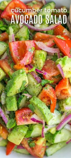 cucumber tomato avocado salad in a white bowl with text overlay