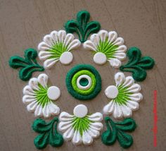 a green and white flower with an evil eye in the center on a brown surface