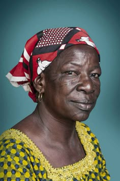 an older woman wearing a red, white and blue head scarf on top of her head