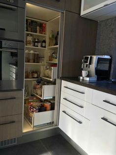 an open refrigerator door in a kitchen