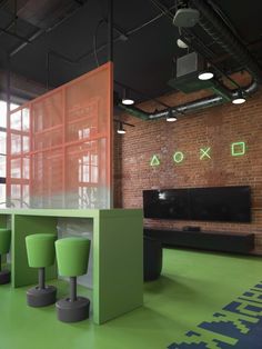 an office with bright green furniture and exposed brick walls, along with neon colored flooring