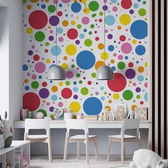 a dining room with colorful polka dot wallpaper