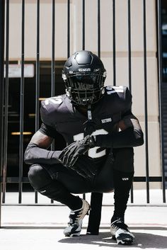 a football player kneels on the ground