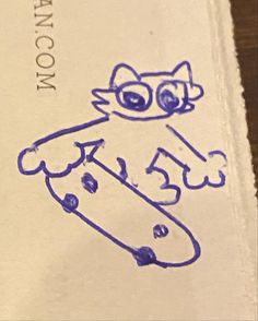 a drawing of a cat holding a skateboard on top of a piece of paper