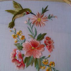 embroidered flowers and birds on white fabric