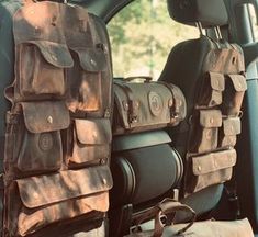 the back seat of a vehicle with several pieces of luggage on it's side