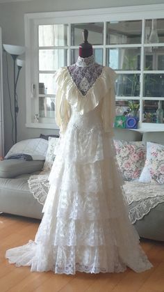 a wedding dress is on display in the living room