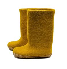 a pair of yellow boots sitting on top of a white floor