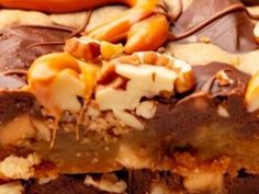 there is a chocolate dessert with nuts and candy on the top, as well as other toppings