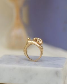 a gold ring sitting on top of a marble block