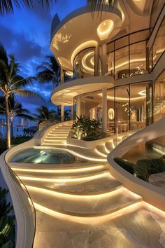 a large white house with stairs leading up to it's windows and palm trees in the background