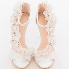 The Ivory Satin Wedding Shoes Floral Embellished Strappy Heeled Sandals exude grace and elegance, crafted from luxurious satin material and embellished with delicate satin flowers. These sandals boast a peep toe design, a back zipper, and a comfortable heel, making them perfect for bridal wear, ensuring both style and comfort on your special day. Handcrafted US sizing. Fits true to size. Heel Height: 4.72" / 120 mm approx Product measurements were taken using size 8. Please note that measurements may vary by size. Material: Crafted from elegant satin material for a luxurious look and feel. Peep Toe Design: Features a stylish peep toe front for added sophistication. Back Zipper: The back zipper design makes it easier to wear.