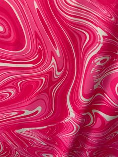 a pink and white background with swirls in the form of liquid or water waves