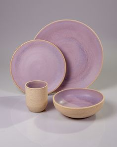 a set of purple dishes and cups