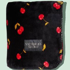 the victoria's secret cherry print blanket is black with red cherries on it