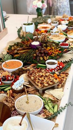 a long table filled with lots of food and dips on top of each other