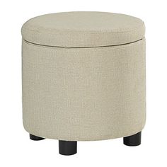 a round ottoman with black legs and an upholstered cushion on the top, in beige