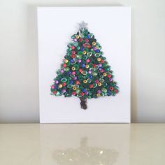 a card with a christmas tree made out of plastic beads on the front and bottom