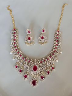 Indian Jewelry Set made with ruby-colored stones and pearls. Perfect for the Indian Bride Indian Jewelry Set, Indian Bridal Jewelry, Spiritual Necklace, Indian Bridal Jewelry Sets, Bride Necklace, Bridal Jewelry Set, Indian Jewelry Sets, Colored Stones, Bridal Jewellery Indian