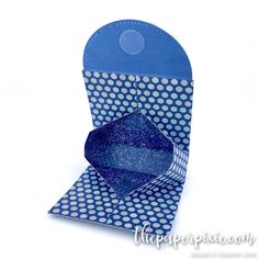 a blue and white card with polka dots on it