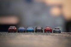 five toy cars lined up in a row