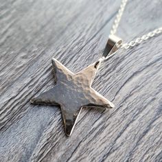 "Hello, thank you for looking at this sterling silver statement star necklace.  The star is approximately 25mm (2.5cm) wide, 25mm (2.5cm) tall and 1mm (0.1cm) thick, it is made from sterling silver sheet. Select from an 18\" (45cm) or 20\" (50cm) Sterling Silver chain. Please message if you would like a different length chain I'm always happy to accommodate changes if I can. I also make two different sized coordinating earrings please click on the links below to take a look https://www.etsy.com/uk/CraftyCatsJewellery/listing/655760479/sterling-silver-hammered-finish-10mm https://www.etsy.com/uk/CraftyCatsJewellery/listing/655769651/sterling-silver-hammered-star-drop Why not purchase a cleaning and polishing kit to keep your new purchase in pristine condition. Use the drop down list and sel Simple Silver Pendant, Star Jewellery, Hammered Silver Jewelry, Womens Silver Jewelry, Simple Silver Jewelry, Jewellery Pendant, Silver Jewelry Diy, Handmade Silver Jewellery, Star Necklace Silver